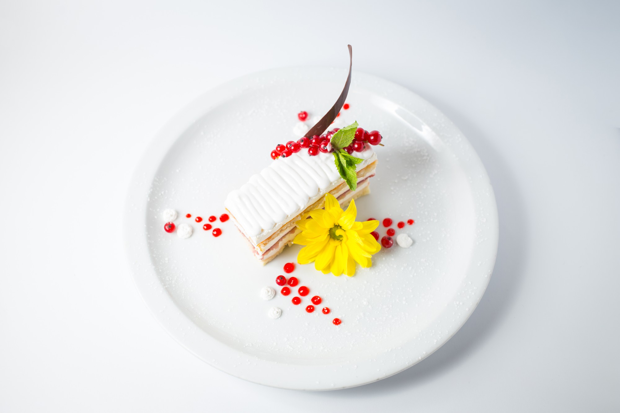 Close-up plated gourmet course with gold accents
